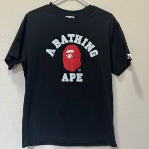 A Bathing Ape Black Tee with vibrant camo design Size S.